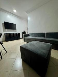 a living room with a couch and a chair at Apartment Camilla in Martil
