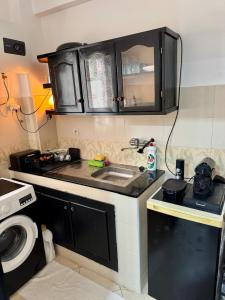 a small kitchen with a sink and a microwave at Apartment Camilla in Martil