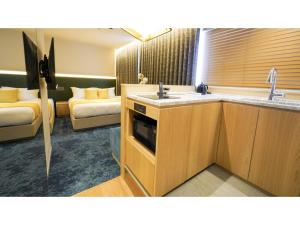 a bathroom with a sink and a living room at THE GALA HOTEL UMEDA - Vacation STAY 24228v in Osaka +16 photos