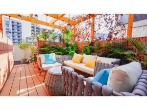 a patio with couches and a table and chairs at THE GALA HOTEL UMEDA - Vacation STAY 24228v in Osaka