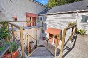 a stairway leading to a backyard with a building at Condo next to a bird sanctuary by Discovery Park in Seattle