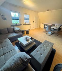 a living room with a couch and a table at Open-Air-BnB Wohnung 76m2 Freudenburg nur 3 min in Bassum