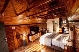 a bedroom with a bed in a wooden room at Resort Peniel Cabanas e Eventos in Campina Grande do Sul +158 photos