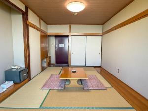 a room with a table in the middle of a room at Takamine Kogen Hotel - Vacation STAY 32774v in Shin-kazawa