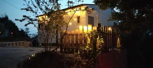 a white house with lights on the side of it at Forest - Vacation STAY 34213v in Tateyama