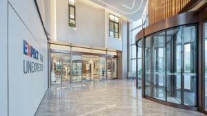 an empty lobby of a building with glass doors at Holiday Inn Express Xi'an Caotang Technology Park by IHG in Fengyukou