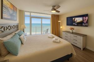 a bedroom with a bed with a view of the ocean at Atlantica Resort in Myrtle Beach +61 photos