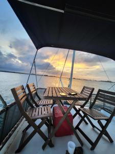 a group of chairs and a table on a boat at PR Rentals Ocean Park Beach Apartment 2 in San Juan +29 photos