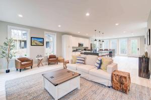 a living room with a white couch and a table at Modern Family Cabin 1 min to Bryce Fire Pit KING Bed in Basye