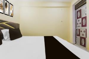 Ένα ή περισσότερα κρεβάτια σε δωμάτιο στο Hotel O Galaxy Inn