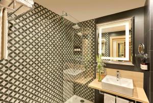 a bathroom with a sink and a shower at NH Campo Cartagena in Cartagena