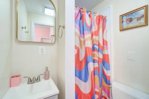 a bathroom with a colorful shower curtain next to a sink at Sweet Tooth Studio 99 Walk Score half Block to King in Alexandria