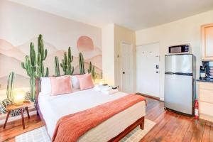 a bedroom with a large bed and a refrigerator at 99 Walk Score half Block to King Western Studio in Alexandria