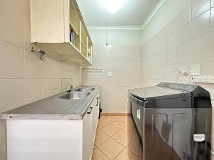 a small kitchen with a sink and a dishwasher at 3 Bedroom House in Nelspruit in Nelspruit +23 photos