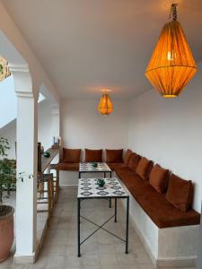 a living room with a couch and a table at Riad Yu Yu in Marrakech +80 photos