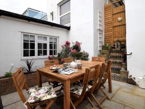 a wooden table and chairs on a patio at 3 Bed in Folkestone 75607 in Sandgate
