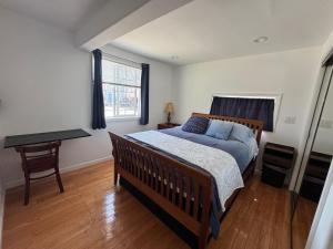a bedroom with a bed and a desk and a window at San Francisco 2 Bedroom with Parking near BART in San Francisco