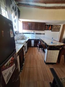 a kitchen with wooden floors and a counter top at Masai 6 in Diani Beach +10 photos