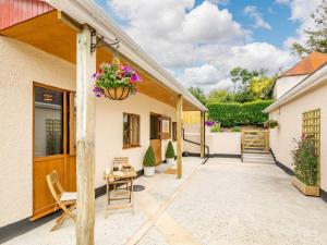a patio of a house with a flower pot at 1 Bed in South Molton 89089 in South Molton