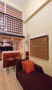 a living room with a couch and a bar at Loft house @ Patar beach in Bolinao