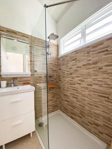 a bathroom with a glass shower and a sink at Villa Cameo in Le Gosier +25 photos