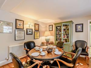 a dining room with a table and chairs at 3 Bed in Harbottle 61257 in Harbottle