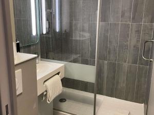 a bathroom with a shower with a glass door at Hotel ibis Narbonne in Narbonne +119 photos