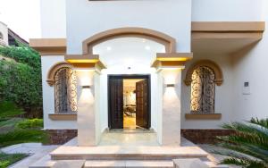 a entrance to a house with a black door at Host Prime Villas in Cairo