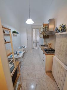 a kitchen with a table and a stove top oven at B&B Vola Vola Vola in Ortona +21 photos