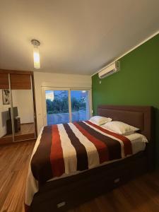 a bedroom with a bed with a striped blanket at Villa Nadia in Bar +2 photos