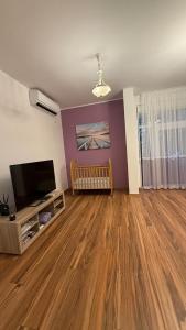 a living room with a crib and a flat screen tv at Villa Nadia in Bar