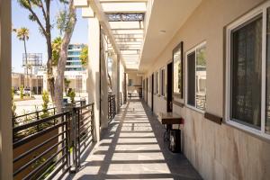 a hallway of a building with a bench on it at Hotel Hacienda Aguacaliente in Tijuana