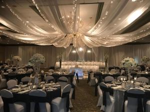 a banquet hall with tables and chairs and a chandelier at Holiday Inn Effingham by IHG in Effingham +50 photos