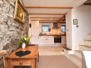 a kitchen with a wooden table and a stone wall at 1 Bed in Richmond 36769 in Reeth +29 photos