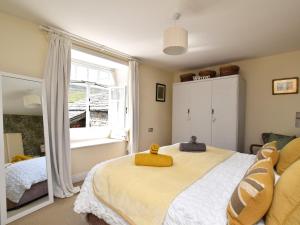 a bedroom with a large bed with a yellow towel on it at 1 Bed in Richmond 36769 in Reeth