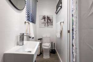 a white bathroom with a sink and a toilet at The Side Villa in Miami +15 photos