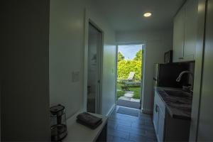 a kitchen with a sink and a door to a patio at The Side Villa in Miami