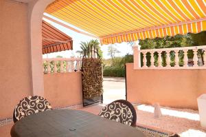 eine Terrasse mit Tisch und Stühlen auf einer Veranda in der Unterkunft Ferienhaus für 4 Personen ca 71 m in Los Urrutias, Murcia Costa Calida in Los Urrutias