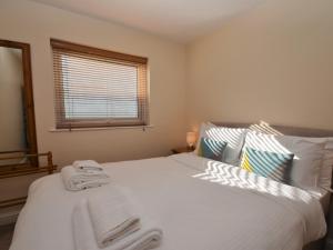 a bedroom with a white bed with towels on it at 2 Bed in Brixham BX054 in Brixham +10 photos