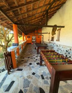 a room with ping pong tables in a building at Recanto Búzios Arpoador Suítes in Búzios