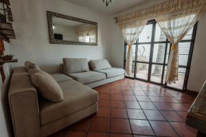 Una sala de estar con un sofá y un espejo. en Quinta Tere Country House, en Tesistán