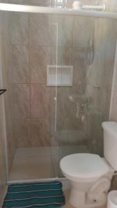 a bathroom with a shower with a toilet and a sink at Pousada Araújo em Paraty in Paraty