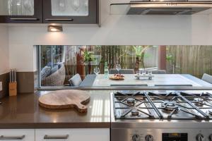 a kitchen with a stove and a counter top at La Luna - Oceanstays in Lennox Head