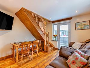 a living room with a couch and a table at 2 Bed in Ilfracombe 81464 in Ilfracombe
