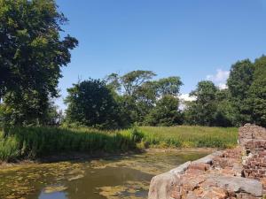 an old stone wall next to a river at Cozy Seaside Retreat in Hojer-By Traum in Højer
