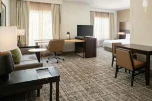 a hotel room with a bed and a desk at Residence Inn by Marriott Houston City Place in Spring