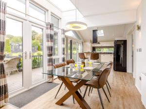 a dining room with a glass table and chairs at 2 Bed in Ilfracombe 87361 in Kentisbury