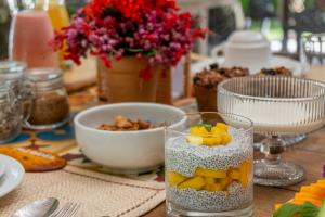 a table with a bowl of fruit in a glass at POUSADA CARMELITHA in Trancoso