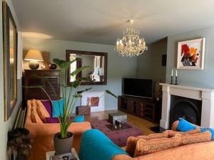 a living room with two couches and a fireplace at Birch House Ballina in Ballina +20 photos