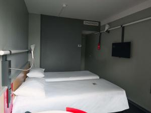 a hospital room with two beds and a flat screen tv at ibis Saintes in Saintes +91 photos